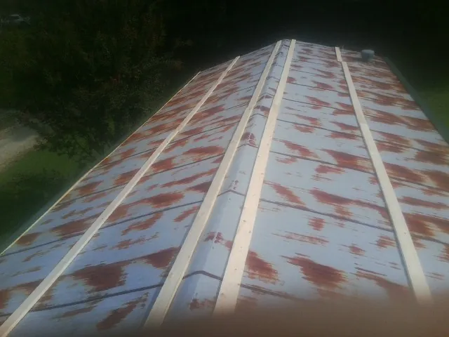 Rusted metal roof panels with new wood purlins before replacement — Storm Damage Roof Repair in Cadiz by Roofing Brothers